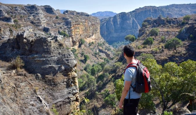 Nomadic Matt standing on a hill looking out over the landscapes of Madagascar