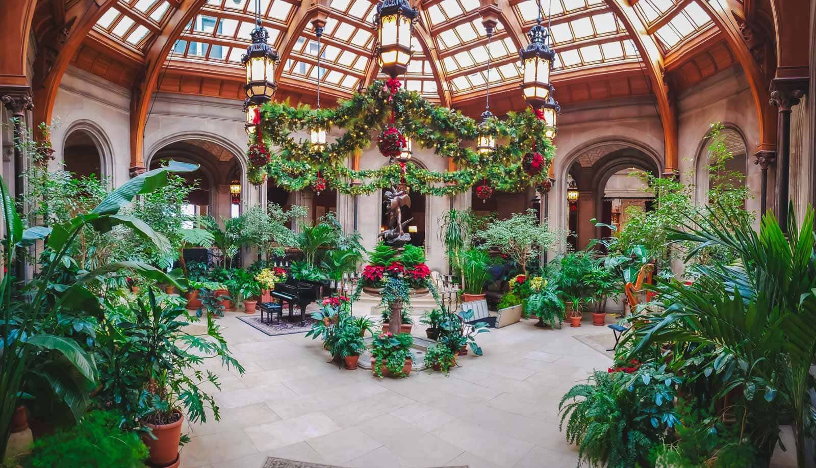 The grand banquet hall at the Biltmore Estate in Asheville, decorated with a giant Christmas tree.